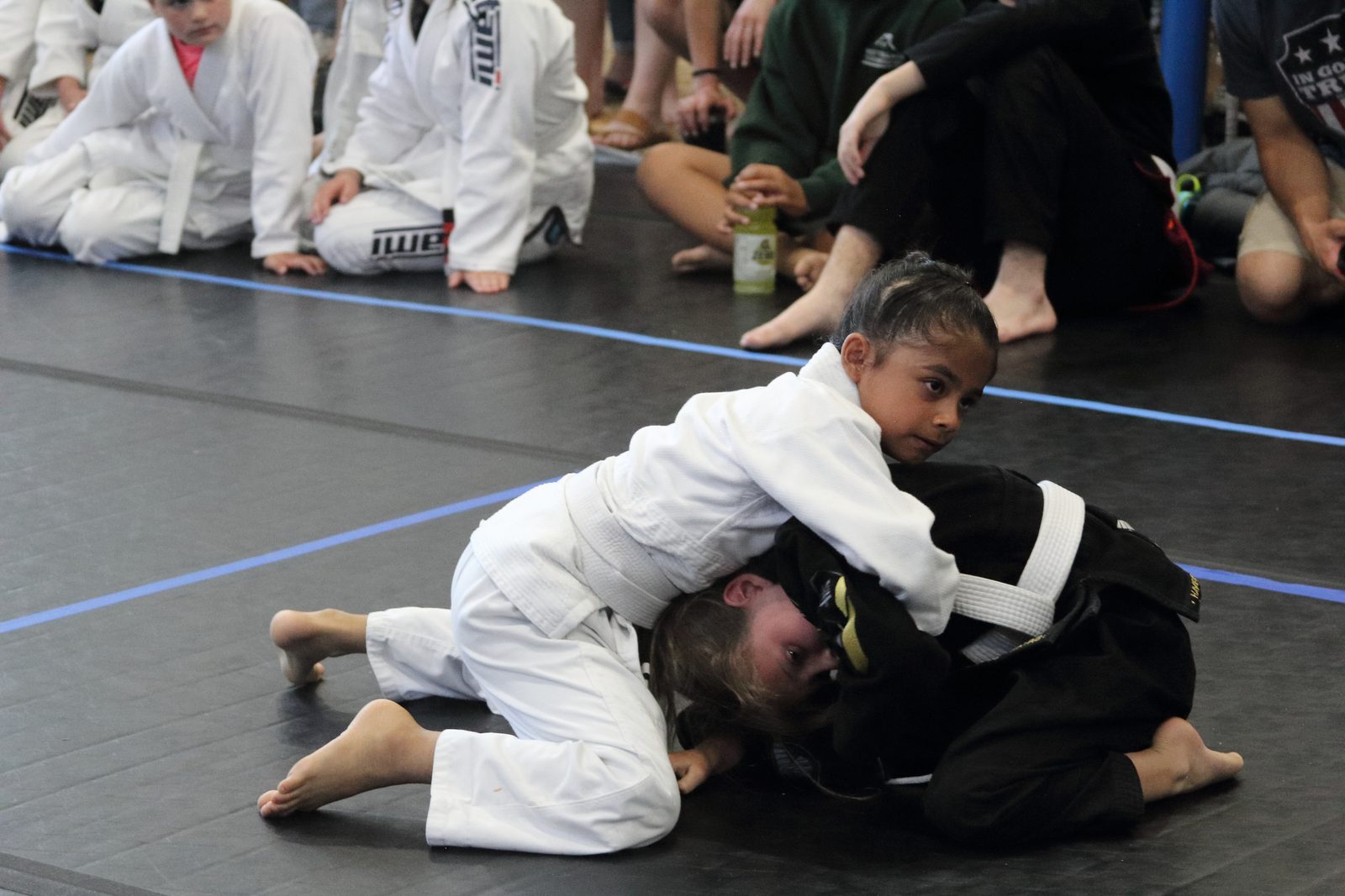 A young student working for position during a grappling round